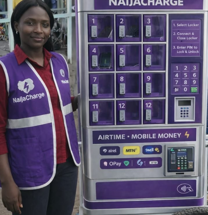 A NaijaCharge operator beside a branded charging unit
