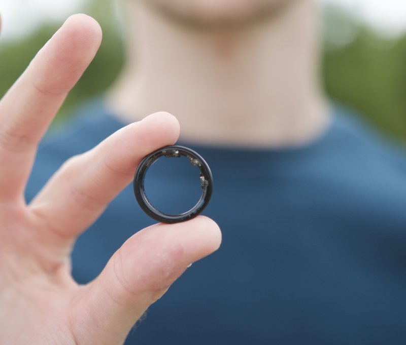 A hand holding an Orukka payment ring